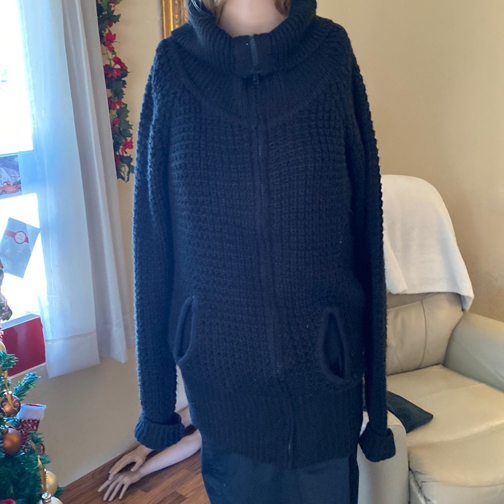 Very warm sweater, long , goes over your bottom and long sleeves .